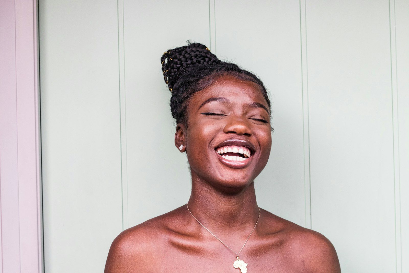 A woman laughing with her eyes closed